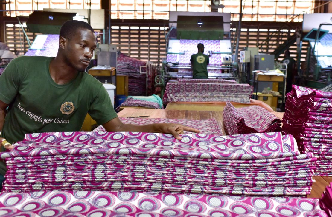 An employee folds loincloths in a production line at the Uniwax factory in Abidjan, Ivory Coast.