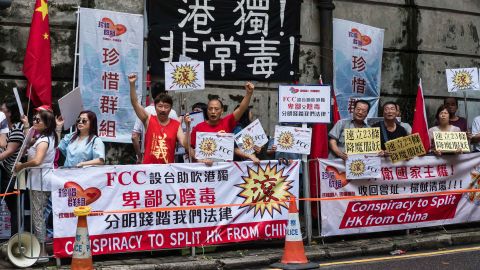 Pro-China protesters hold banners during a demonstration outside the Foreign Correspondents' Club in Hong Kong, on August 14, 2018.