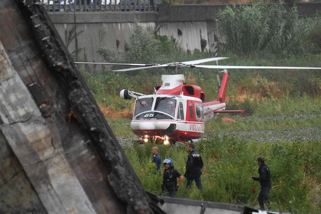 A rescue helicopter lands near the site of the collapse.