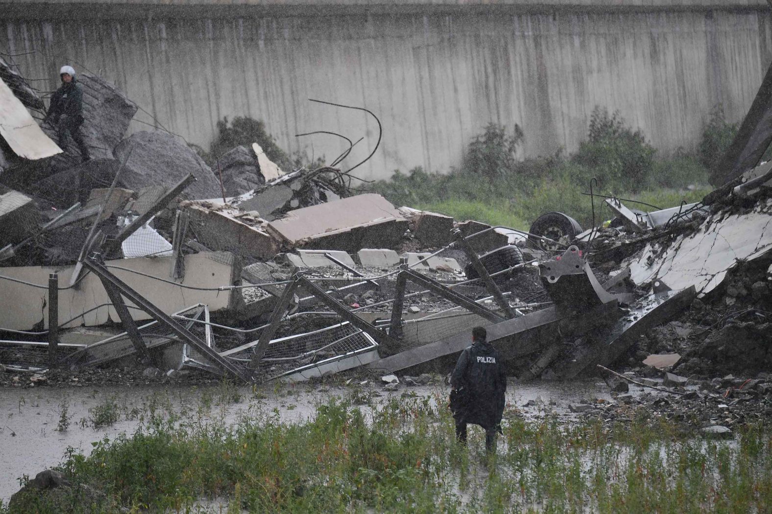 An emergency services worker views the bridge debris.