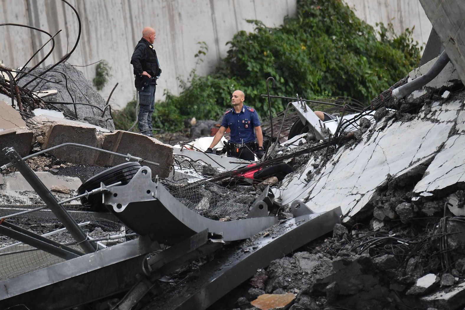 Rescues work among the twisted debris.