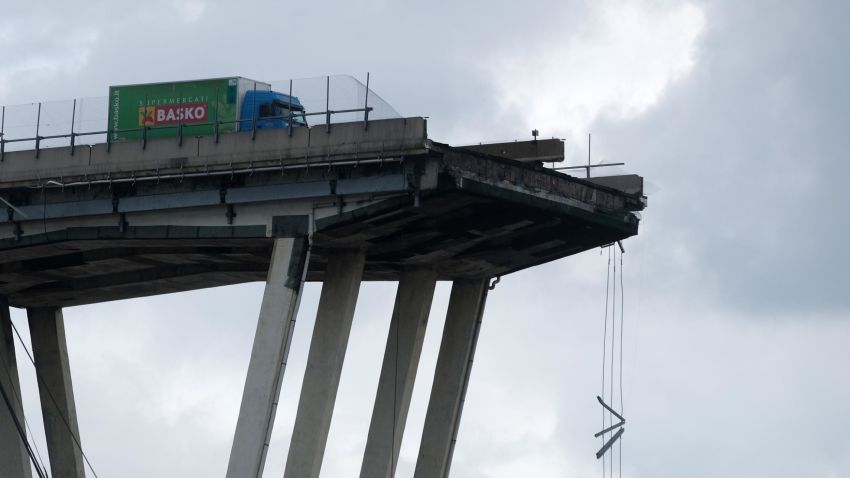 TOPSHOT - A picture taken on August 14, 2018 in Genoa shows a view of the Ponte Morandi motorway bridge, after one of its section collapsed injuring several people. - Rescuers scouring through the wreckage after part of a viaduct of the A10 freeway collapsed said there were "tens of victims", while images from the scene showed an entire carriageway plunged on to railway lines below. (Photo by ANDREA LEONI / AFP)        (Photo credit should read ANDREA LEONI/AFP/Getty Images)