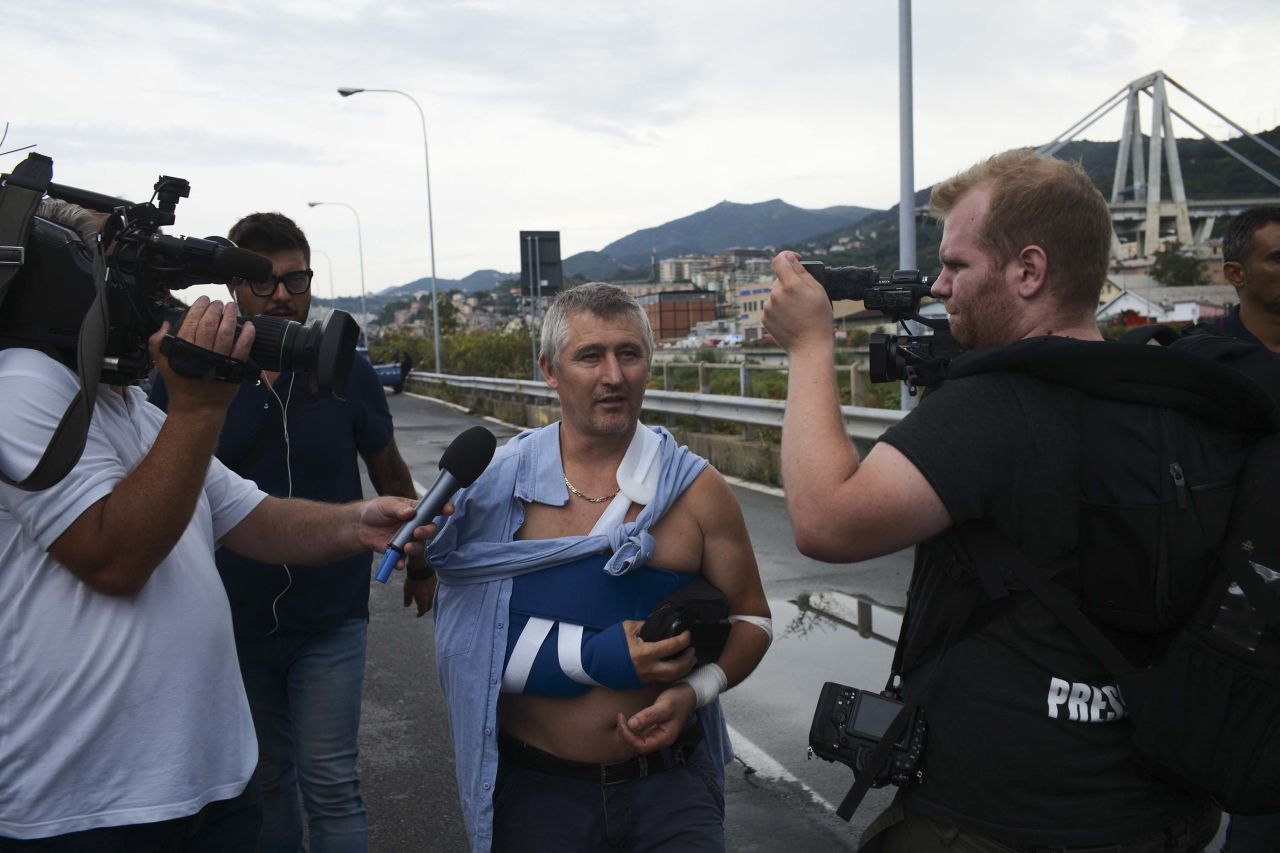 An injured man speaks to reporters near the bridge.