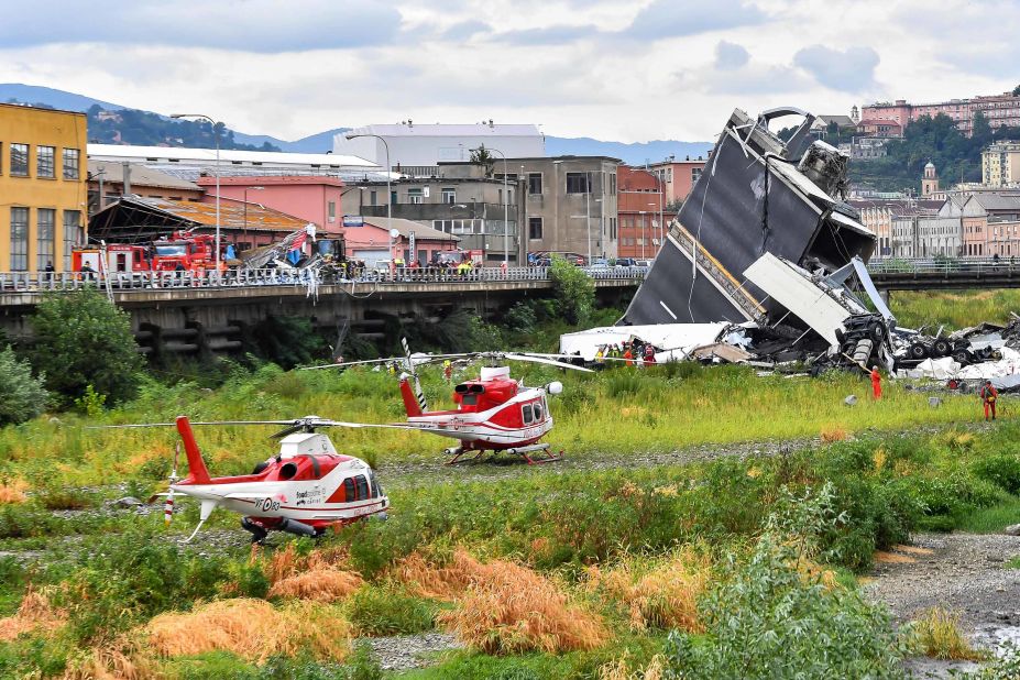 Two rescue helicopters land near the Morandi Bridge.