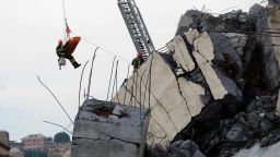 Rescuers are at work amid the rubble and wreckage of the Morandi motorway bridge after a section collapsed earlier in Genoa on August 14, 2018. - At least 30 people were killed on August 14 when the giant motorway bridge collapsed in Genoa in northwestern Italy. The collapse, which saw a vast stretch of the A10 freeway tumble on to railway lines in the northern port city, was the deadliest bridge failure in Italy for years, and the country's deputy transport minister warned the death toll could climb further. (Photo by ANDREA LEONI / AFP)        (Photo credit should read ANDREA LEONI/AFP/Getty Images)