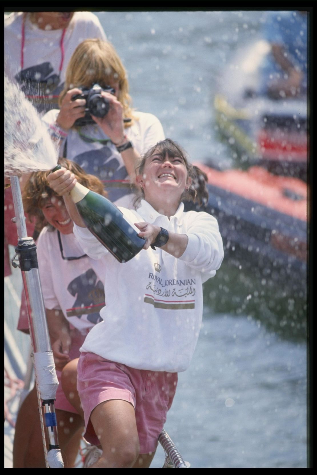 Tracy Edwards, skipper of Maiden, celebrates with champagne after finishing second during the Whitbread round the world yacht race in 1990.