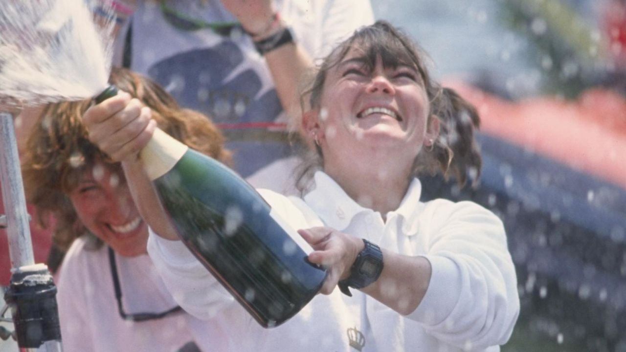 Tracy Edwards, skipper of Maiden, celebrates with champagne after finishing second during the Whitbread round the world yacht race in 1990.