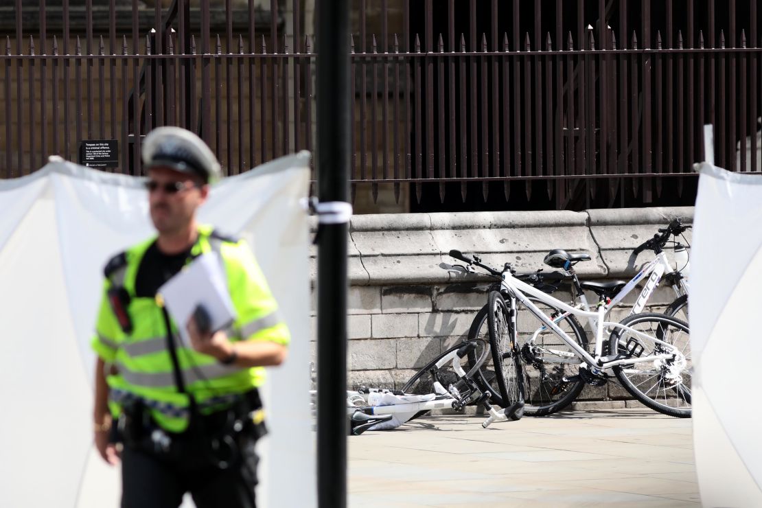 Police officers stand guard near bicycles believed to have been damaged in the crash