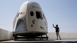 An attendee takes pictures of a mock up of the Crew Dragon spacecraft ahead of the NASA Commercial Crew Program (CCP) astronaut visit at the Space Exploration Technologies Corp. (SpaceX) headquarters in Hawthorne, California, U.S., on Monday, Aug. 13, 2018. Astronauts on SpaceX's Crew Dragon will be the first to fly on an American-made, commercial spacecraft to and from the International Space Station on their mission scheduled for April 2019. Photographer: Patrick T. Fallon/Bloomberg via Getty Images
