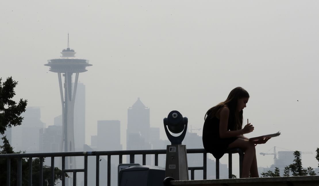 Smoky haze obscures the Space Needle and downtown Seattle on August 14.