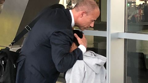 Attorney Michael Avenatti hugs his client, Antony Ortiz, 9.
