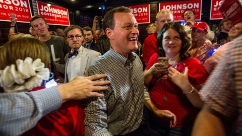 Minnesota gubernatorial candidate Jeff Johnson, center, is greeted by his supporters after returning to the watch party, Tuesday, Aug. 14, 2018.