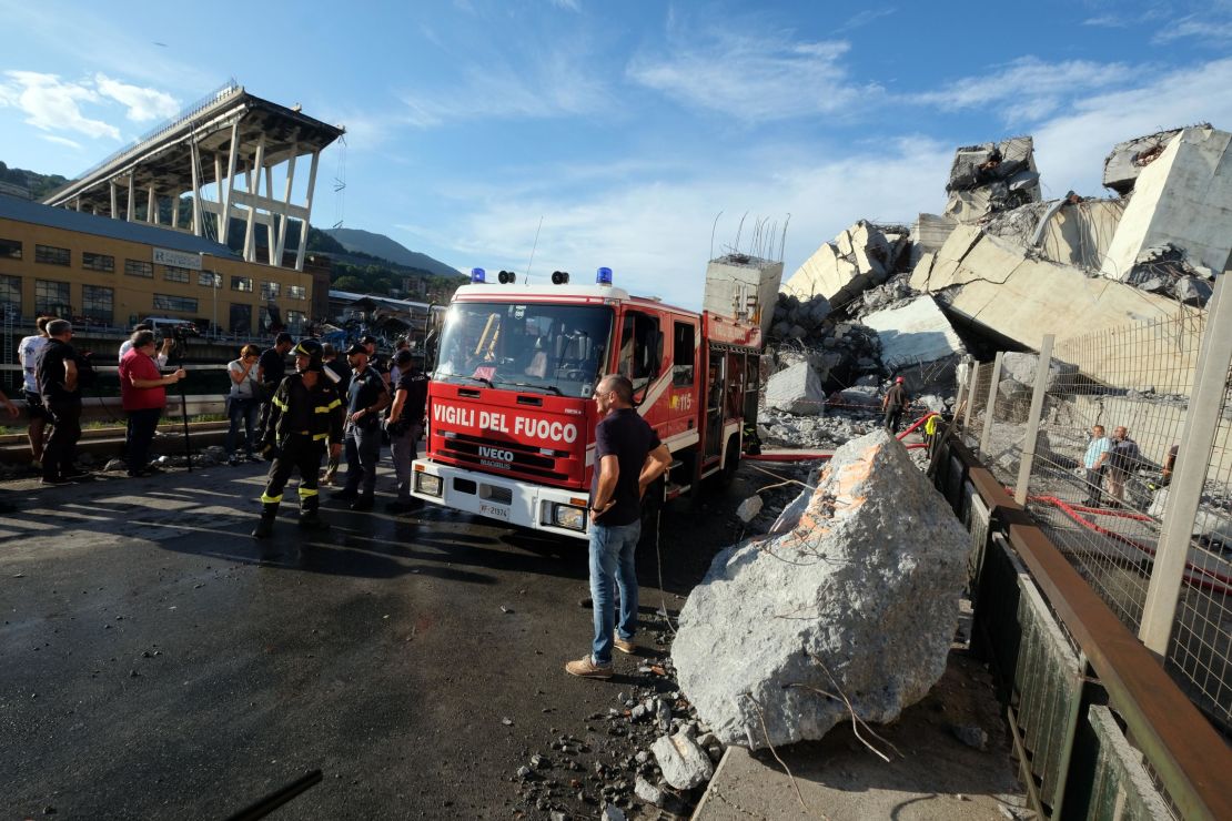 Rescuers inspect the rubble and wreckages by the Morandi motorway bridge after a section collapsed earlier in Genoa on August 14, 2018.