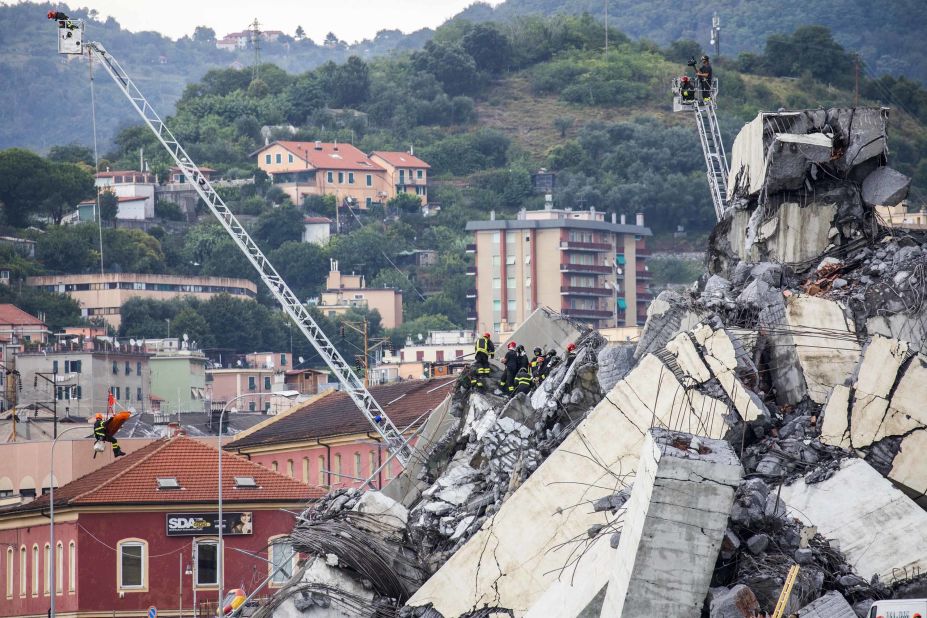 Rescue crews work on Tuesday, August 14, 2018, to recover survivors amid the remains of the collapsed Morandi Bridge in Genoa, Italy.