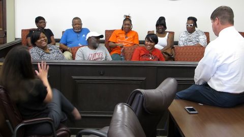 Prosecutors Marie Broder, left, and Ben Coker present a plea deal to the Coggins family August 8.