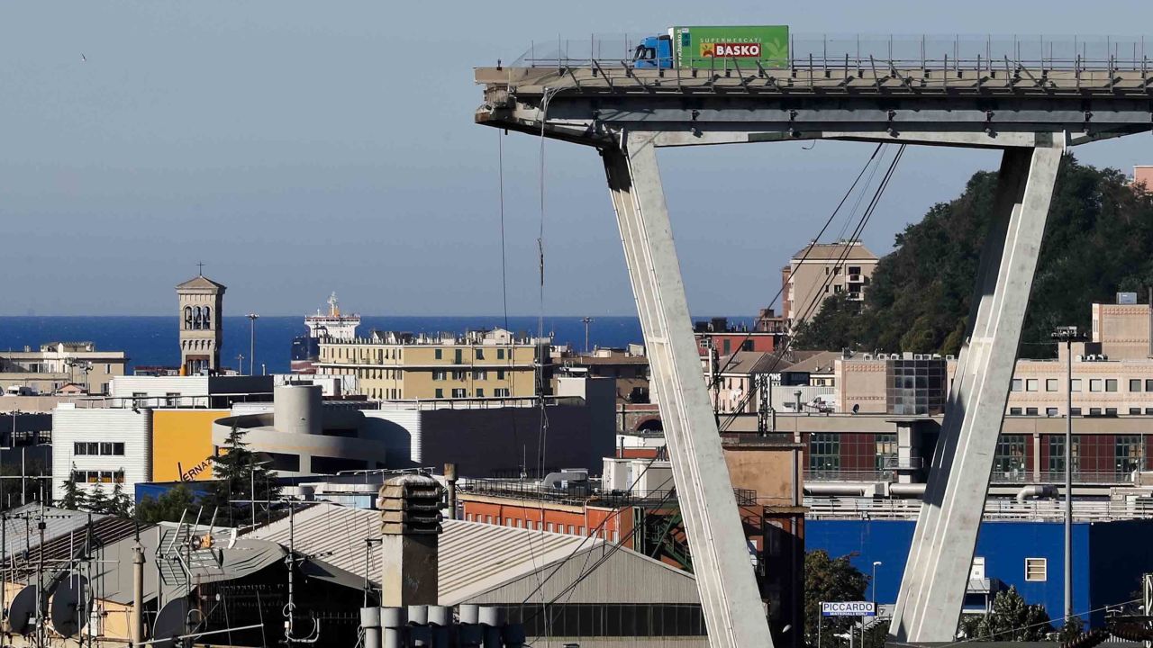 A view of the Morandi highway bridge that collapsed in Genoa, northern Italy, Wednesday, Aug. 15, 2018. A large section of the bridge collapsed over an industrial area in the Italian city of Genova during a sudden and violent storm, leaving vehicles crushed in rubble below. (AP Photo/Antonio Calanni)