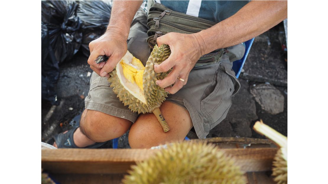 Cracking open a durian. 
