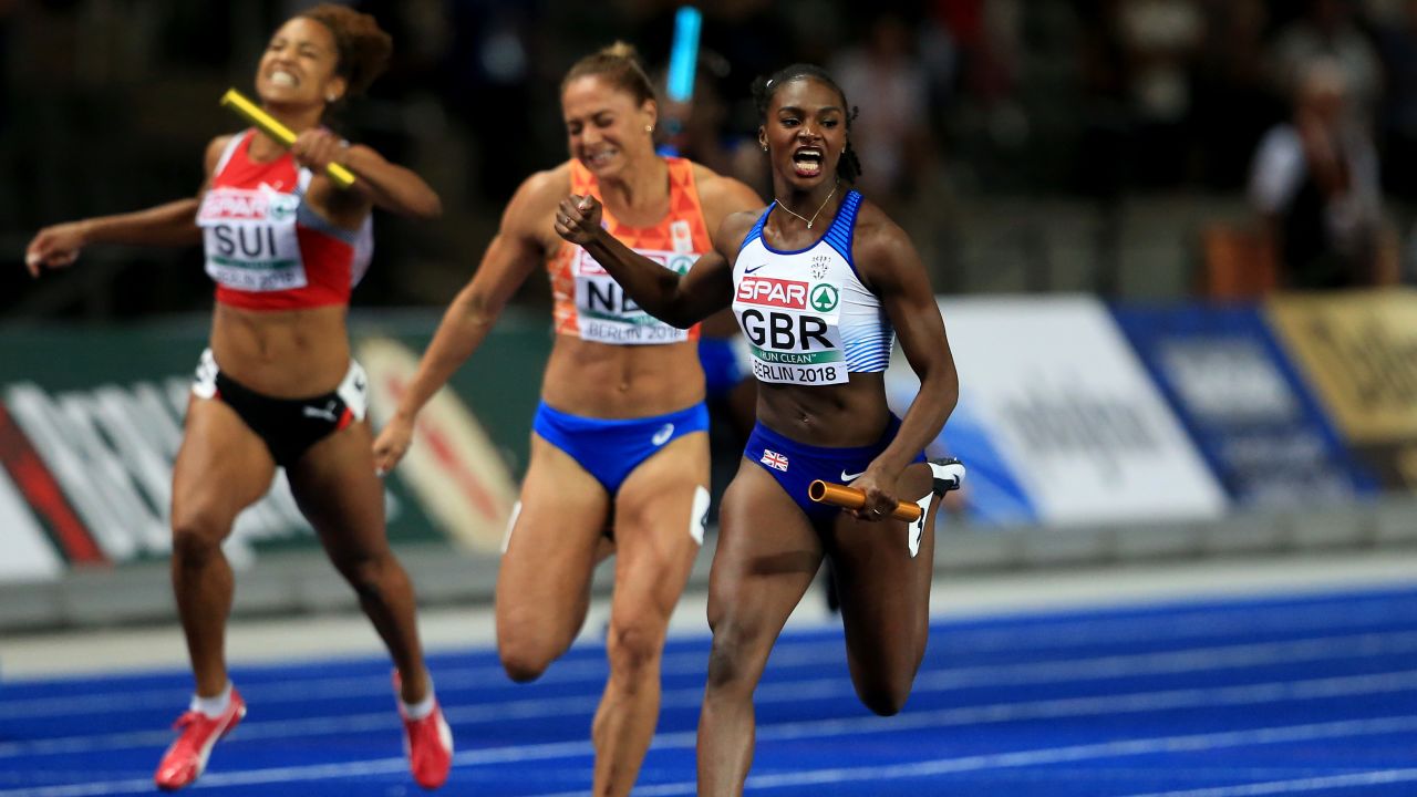 Dina Asher-Smith crossing the line to win gold in the 4 x 100m relay race.