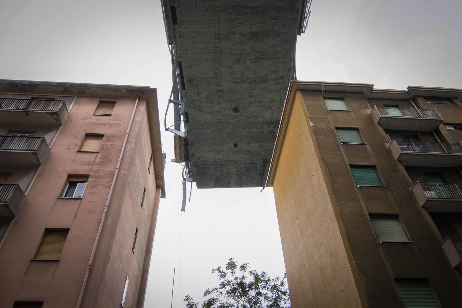 A remaining section of the bridge looms amid buildings in Genoa.