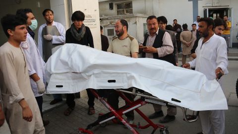 Afghan volunteers carry a body on a stretcher to a hospital Wednesday after a suicide attack in Kabul.