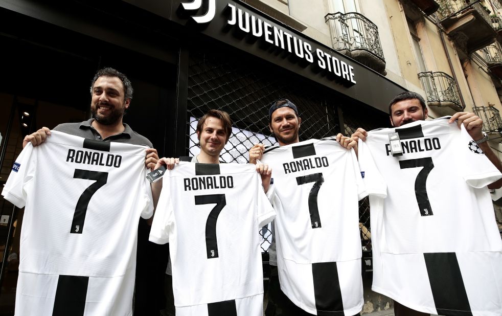 Juve supporters show off their Cristiano Ronaldo jerseys in front of the club's shop in Turin after the Serie A team signed the Portuguese star.