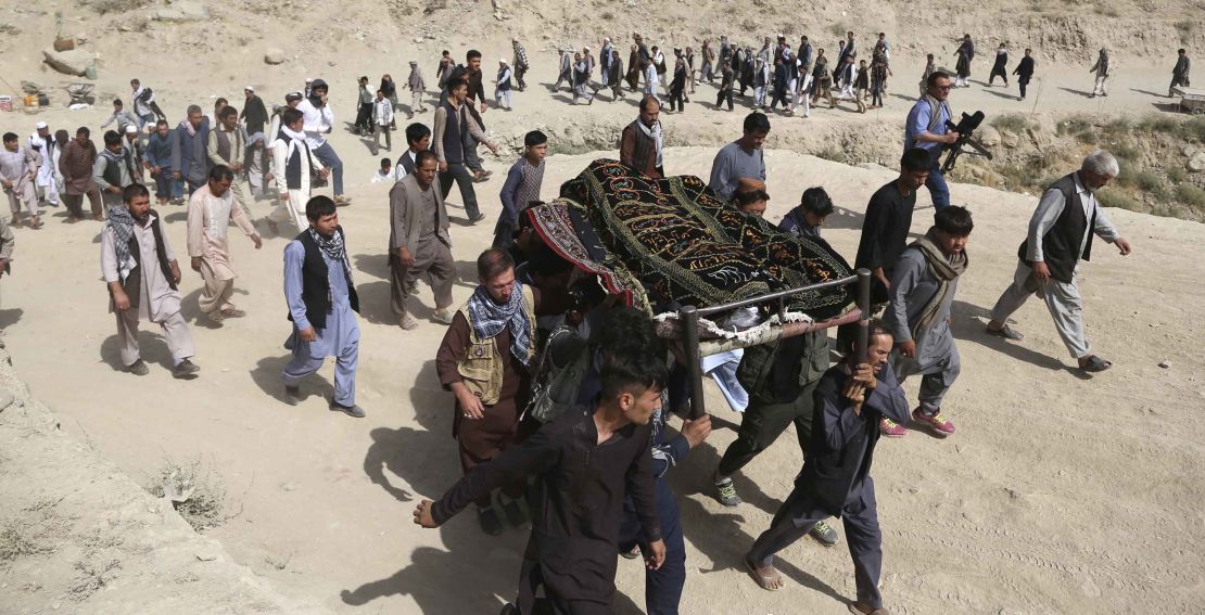 Men carry the coffin of a relative who died in a suicide bombing that targeted a training class in western Kabul, Afghanistan. 