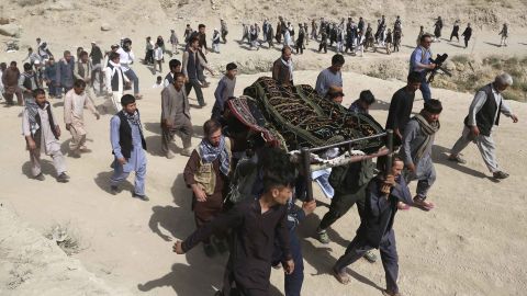 Men carry the coffin of a relative who died in a suicide bombing that targeted a training class in western Kabul, Afghanistan.