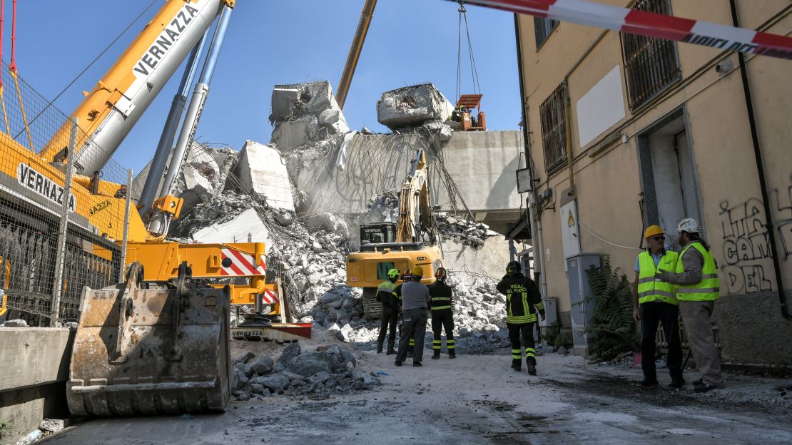 Rescuers inspect the rubble at the Morandi Bridge on Thursday, two days after a large section collapsed.