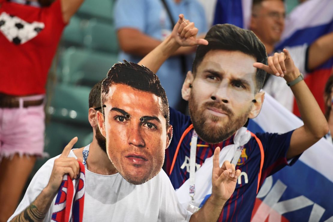 Fans wear Ronaldo and Messi masks during the Russia 2018 World Cup.