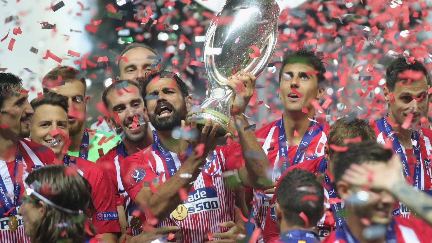 Diego Costa of Atletico Madrid celebrates with the trophy following his team's UEFA Super Cup victory over Real Madrid.