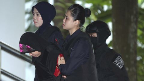 Siti Aisyah, left, is escorted by police as she arrives for Thursday's hearing at Shah Alam High Court.