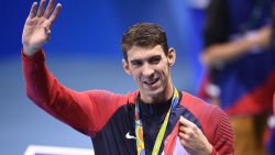 USA's gold medallist Michael Phelps waves after the podium ceremony of the Men's swimming 4 x 100m Medley Relay Final at the Rio 2016 Olympic Games at the Olympic Aquatics Stadium in Rio de Janeiro on August 13, 2016.   / AFP / Martin BUREAU        (Photo credit should read MARTIN BUREAU/AFP/Getty Images)