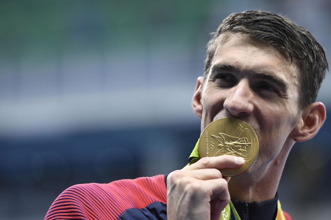 Michael Phelps celebrates with his gold medal during the podium ceremony for the Men's 4x200m Freestyle Relay Final at the 2016 Olympics.
