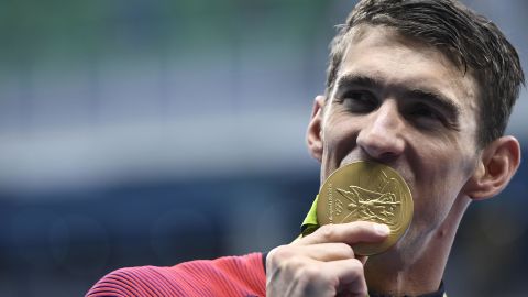 Michael Phelps celebrates with his gold medal during the podium ceremony for the Men's 4x200m Freestyle Relay Final at the 2016 Olympics.