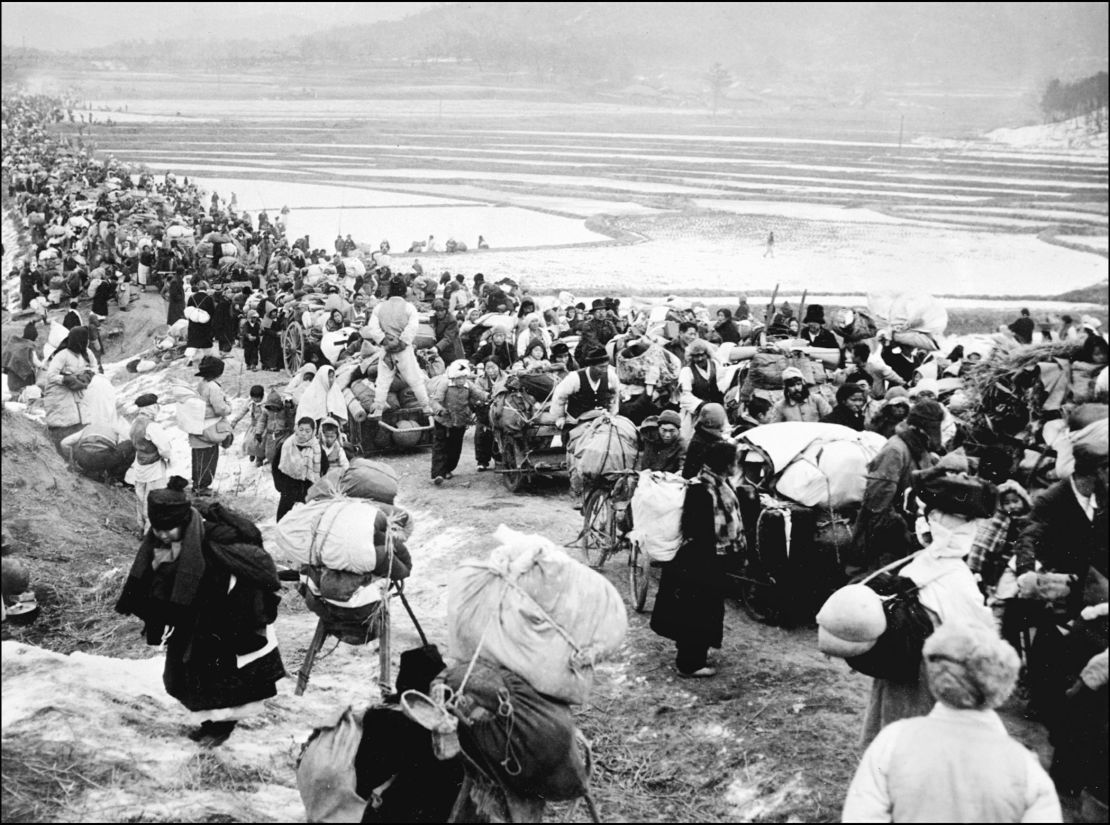 Picture taken on January, 18, 1951 shows Korean refugees fleeing to the south, as they pass by frozen rice fields.