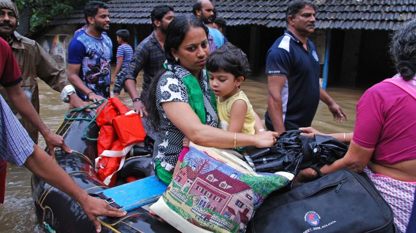 Indian volunteers and rescue personnel evacuate local residents in a boat in a residential area at Kozhikode, in the Indian state of Kerala, on August 16, 2018. - The death toll from floods in India's tourist hotspot of Kerala increased to 77 on August 16, as torrential rainfall threatened new areas, officials told AFP. (Photo by - / AFP)-/AFP/Getty Images