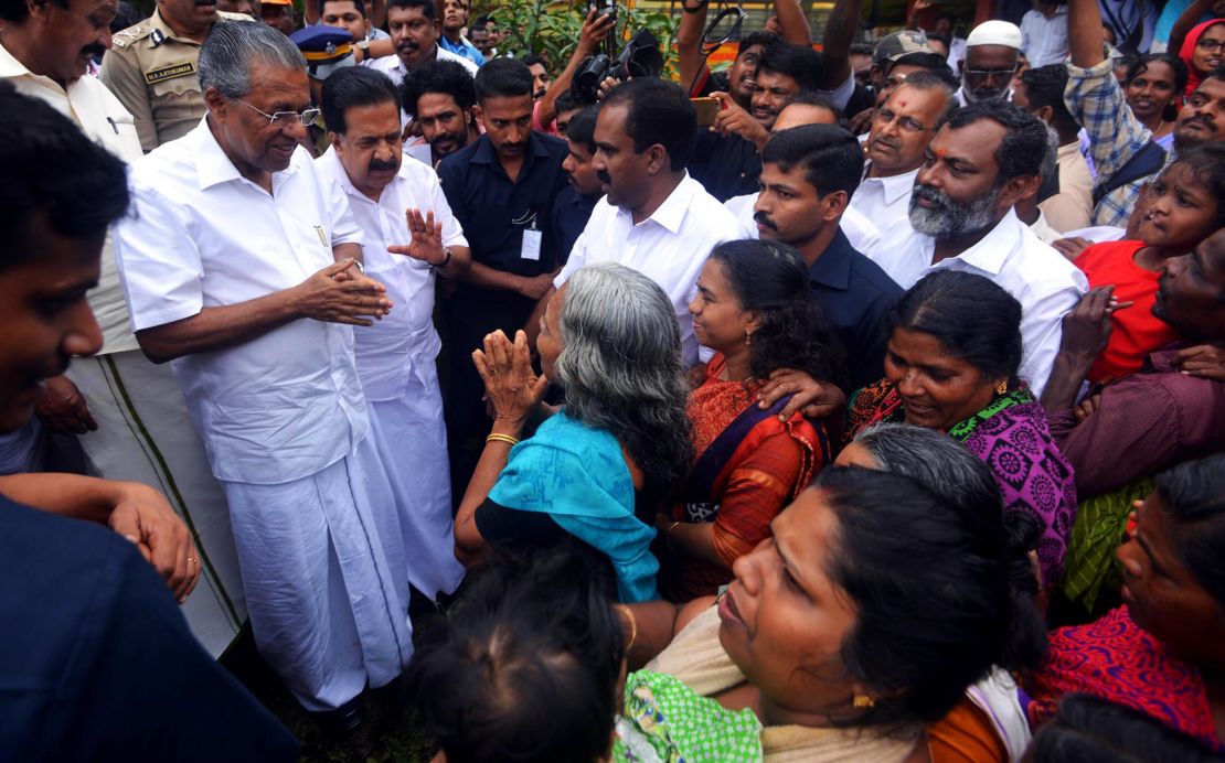 Kerala Chief Minister Pinarayi Vijayan (left) visits a relief camp in the Indian state of Kerala on August 11.