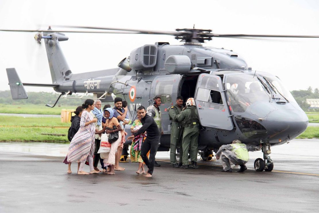 The Indian Navy sends divers with boats and relief items to flood-affected areas.