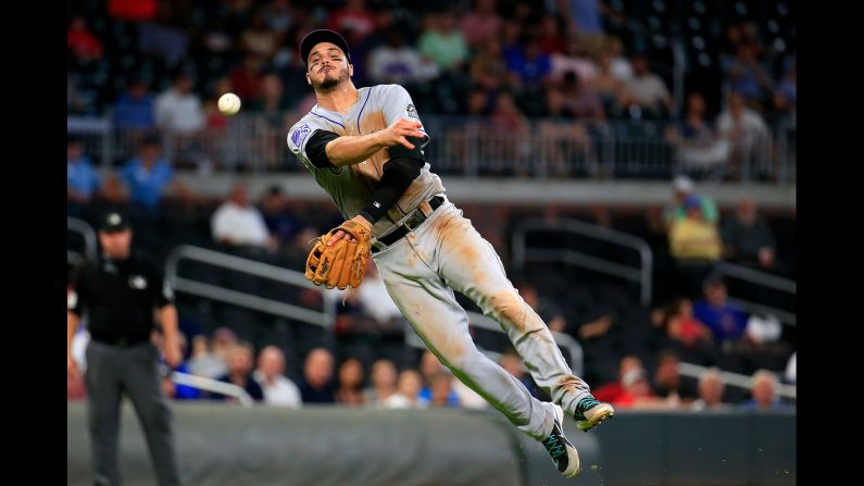 Nolan Arenado of the Colorado Rockies throws to first for an out during the eighth inning of a baseball game against the Atlanta Braves on Thursday, August 16, in Atlanta. The Rockies won 5-3.