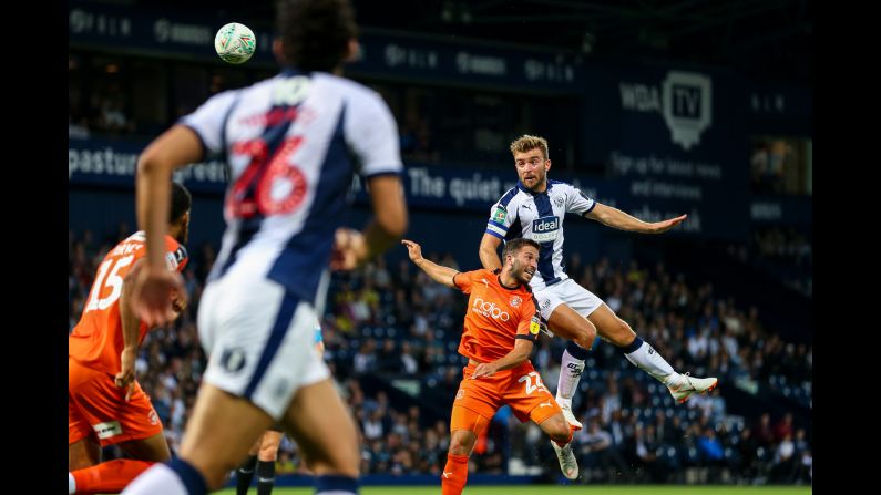 James Morrison of West Bromwich Albion jumps over Luke Gambin of Luton Town for a header during a Carabao Cup match on Tuesday, August 14, in West Bromwich, England.
