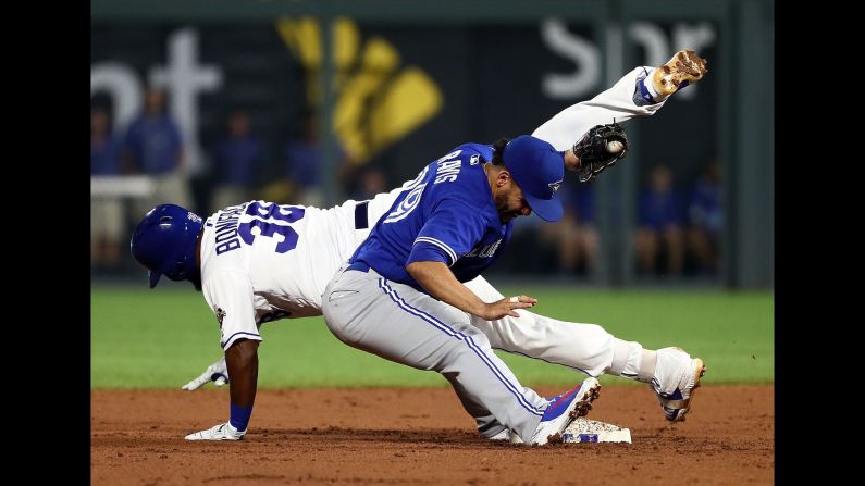 Jorge Bonifacio of the Kansas City Royals is tagged out by Devon Travis of the Toronto Blue Jays in the second inning of the game on Thursday, August 16. The Royals beat the Blue Jays 6-2.