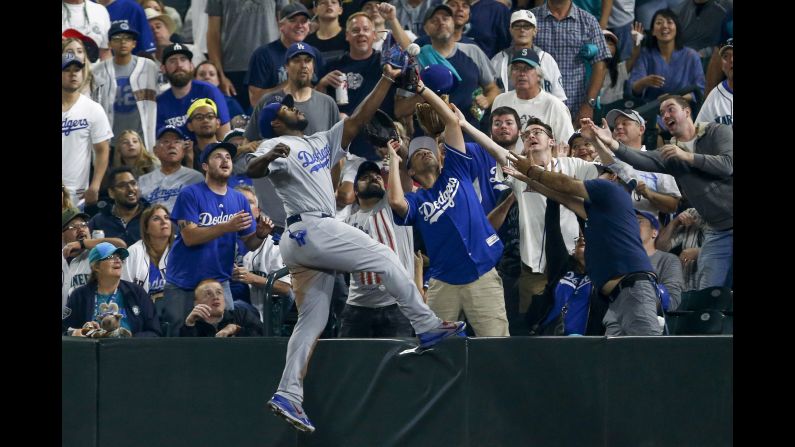 Los Angeles Dodgers right fielder Yasiel Puig fails to catch a foul ball against the Seattle Mariners during the fifth inning of the baseball game in Seattle on Saturday, August 18.