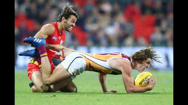 Jarrod Berry of the Brisbane Lions is tackled by Lachie Weller of the Gold Coast Suns during an Australian Football League match on Saturday, August 18, in Gold Coast, Australia.