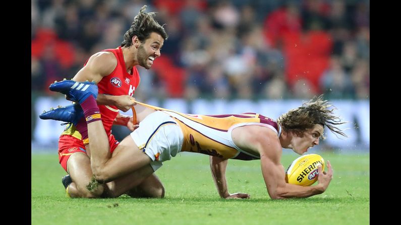 Jarrod Berry of the Brisbane Lions is tackled by Lachie Weller of the Gold Coast Suns during an Australian Football League match on Saturday, August 18, in Gold Coast, Australia.