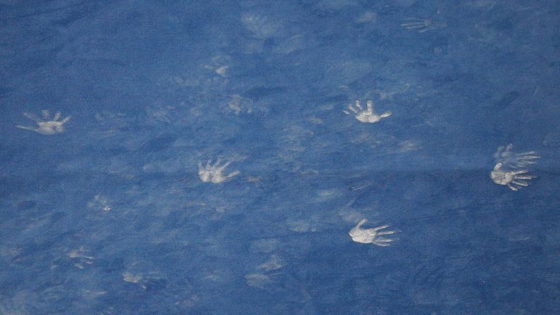 Chalk handprints are left on the floor exercise mat during the men's senior competition at the US Gymnastics Championships in Boston on Thursday, August 16.