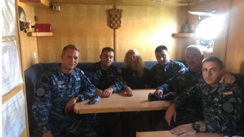 Kay Longstaff sits with members of the Croatian Coast Guard.