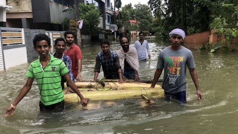 Rescuers wade through the floodwaters.