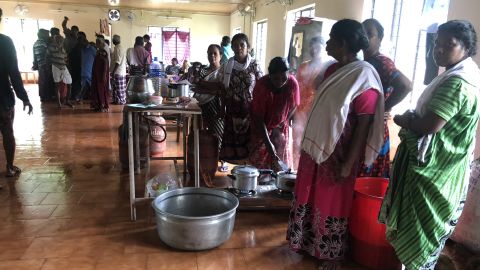 Women prepare lunch at a temporary relief camp set up in a local health center in Kerala.