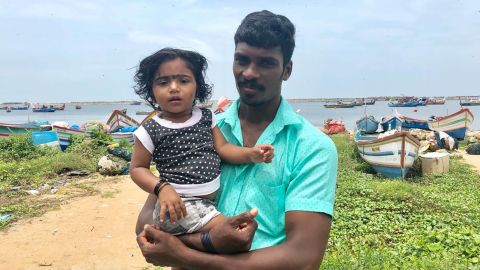 Fisherman Arun Michael with his daughter, Andrea Marie, after he and other rescuers evacuated more than 1,500 people over three days.