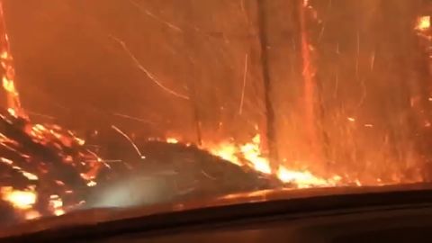 Justin Bilton recorded the fire roaring just outside his car as he drove.
